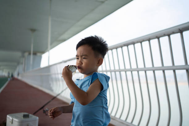 Asian little boy playing happily on the bridge