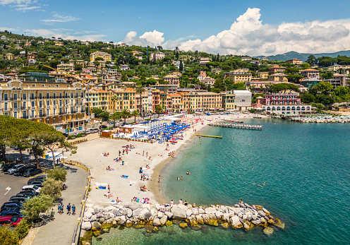 An aerial view of town, the beach, and sunbathers in Santa Margherita, Cinque Terre, Italy.