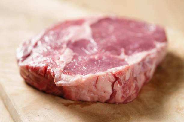istock raw rib eye steak on board closeup 1497440835