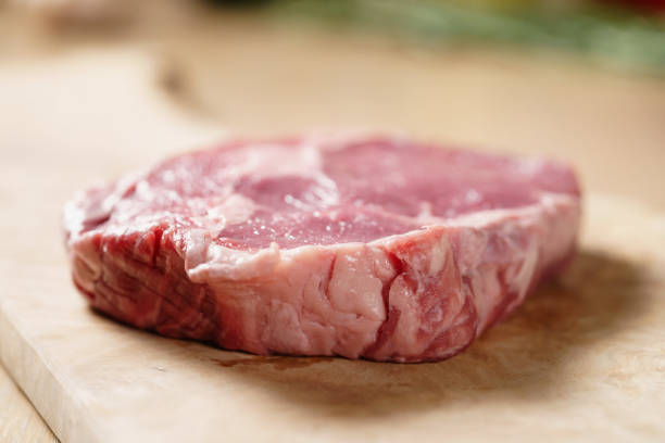 istock raw rib eye steak on board closeup 1497440862