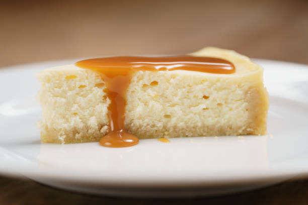 istock caramel sauce pour on cheesecake on plate closeup 1497442638