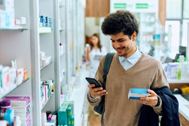 istock Happy Muslim man using mobile phone while looking for a medicine in a pharmacy. 1497445533
