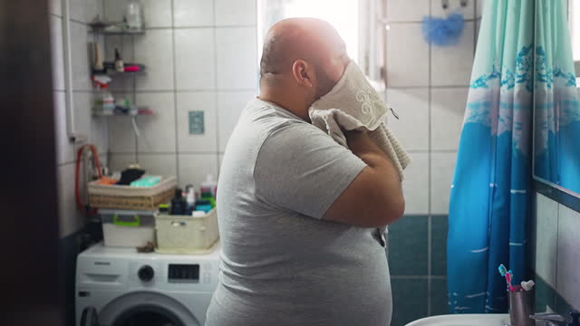 Overweight Male Washing His Face