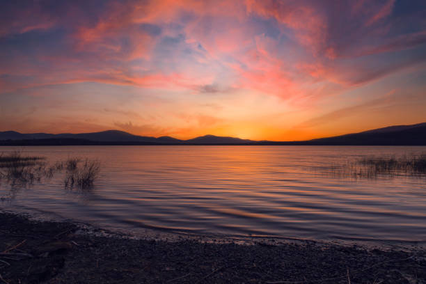 A picturesque sunset over a spring lake and a colorful sky in the background, Poland