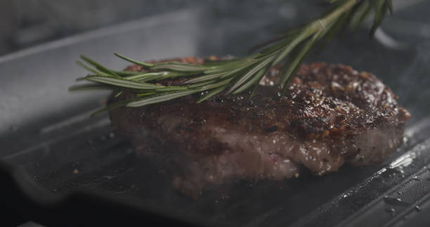istock cooking rib eye steak with herbs on grill pan 1497447363