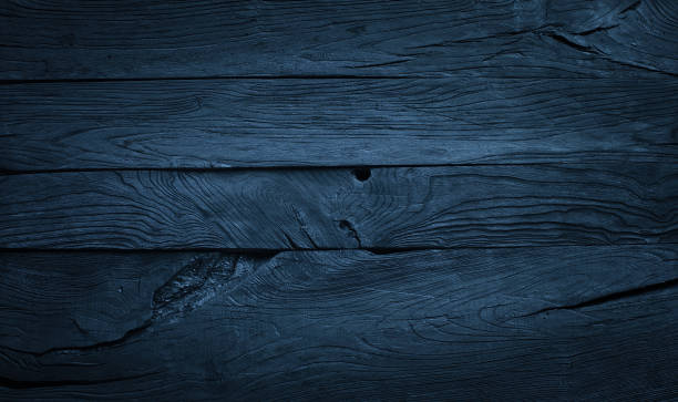 istock dark blue wood background, charred planks 1497448045
