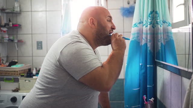Overweight Male Prioritizes Oral Health Brushing Teeth with Purpose