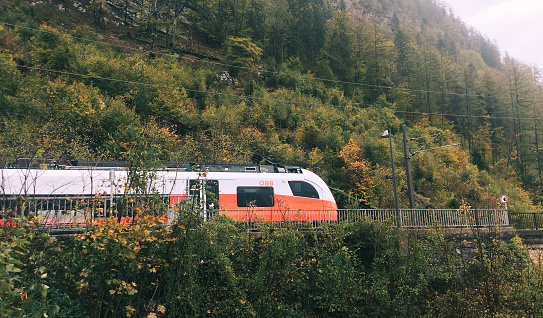 Hallstatt, Austria - Oct 24, 2018. Touristic train running in Hallstatt, Austria. Hallstatt is a charming lakeside village in the Alps.