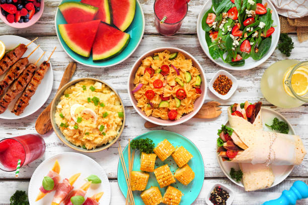 istock Summer food table scene over a white wood background, overhead view 1497453120