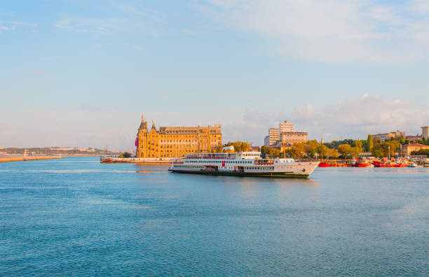 Haydarpasa Terminal, view from Kadikoy. Passenger ferry sails near building.