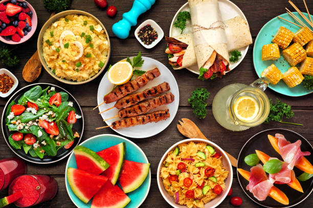 istock Summer food table scene over a dark wood background, above view 1497454063
