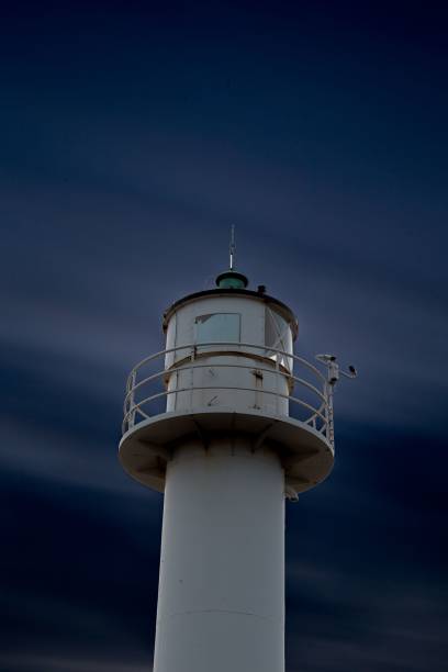 istock Impressive lighthouse tower rising high against a cloudy sky 1497458381