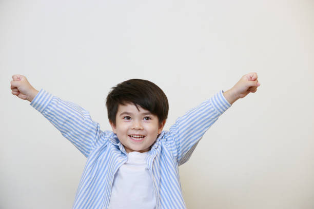 istock A little boy in a polite shirt showing a happy expression on a white background 1497459299