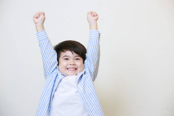 istock A little boy in a polite shirt showing a happy expression on a white background 1497459303