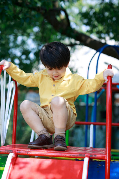 uśmiechnięty słodki chłopiec bawiący się zabawkami na podwórku. - child asian and indian ethnicities facial expression asia zdjęcia i obrazy z banku zdjęć