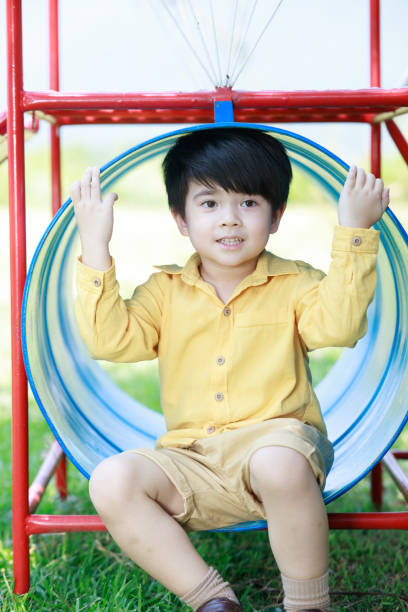 istock Smiling cute boy having fun playing with toys in the backyard. 1497459864