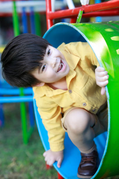istock Smiling cute boy having fun playing with toys in the backyard. 1497459867