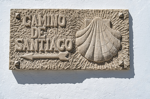 Camino de santiago stone sign carved shell and arrow in Laredo to Santoña Santona in Cantabria Spain
