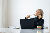 Adult blonde woman having a call