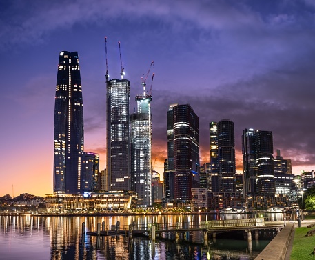 Sydney, Australia – February 09, 2023: A view of the Sydney skyline at sunset, featuring tall, modern skyscrapers situated along a waterfront