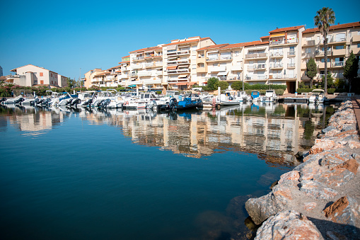 Canet-en-Roussillon boat marina with city reflection in the sea water -  In the heart of the Catalan country