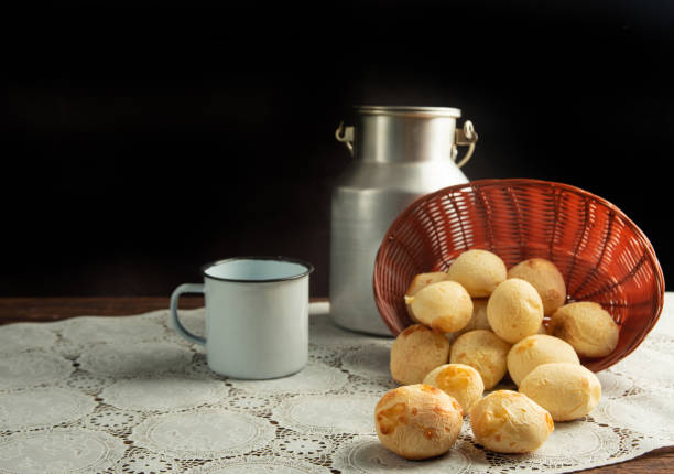 istock Cheese bread, Basket with cheese bread lying on a white lace tablecloth and accessories, dark background, selective focus. 1497475399