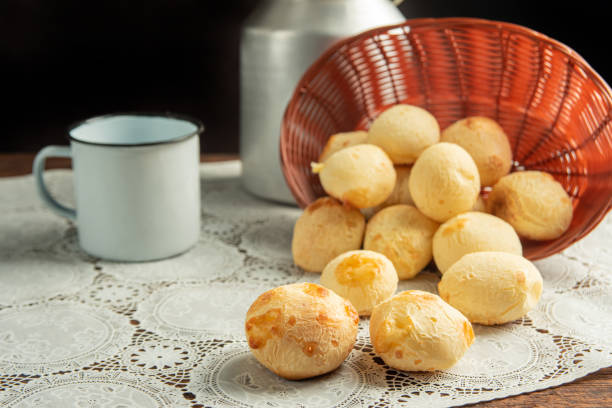 istock Cheese bread, Basket with cheese bread lying on a white lace tablecloth and accessories, dark background, selective focus. 1497475401