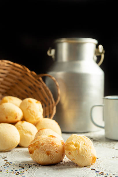 istock Cheese bread, Basket with cheese bread lying on a white lace tablecloth and accessories, dark background, selective focus. 1497475433