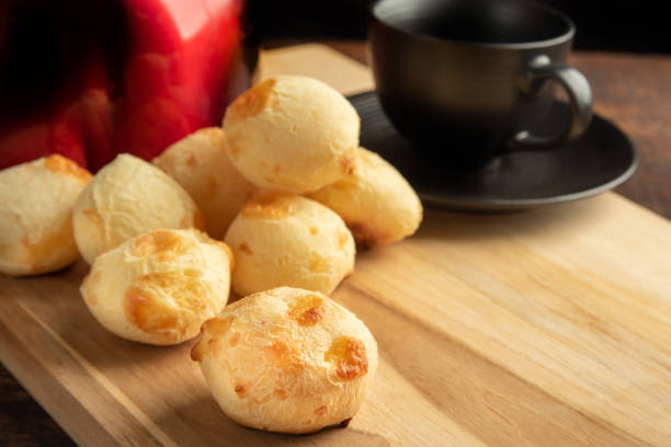 istock Cheese bread, Basket with cheese bread lying on rustic wood, red kettle and accessories, dark background, selective focus. 1497475489