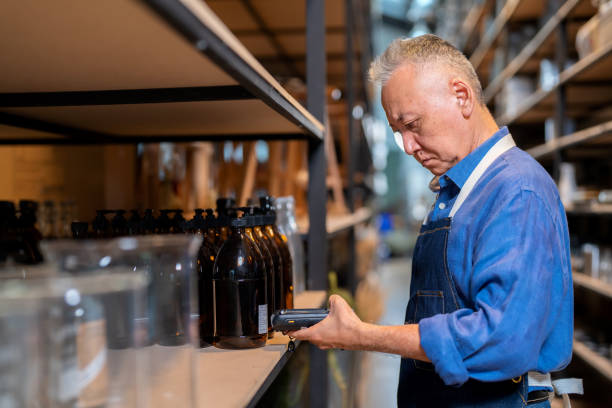istock Good inventory management system keeps inventory organized and allows small businesses growth sustainable. Warehouse manager looking at digital tablet and walking in the storeroom inspector the product on shelf at home decoration factory. 1497476598