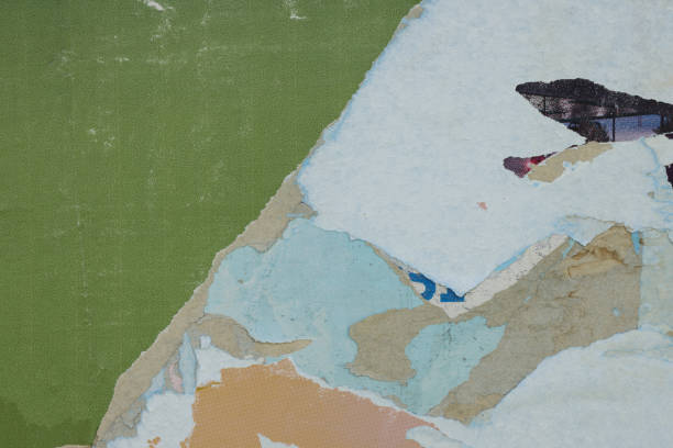 istock Pieces of torn paper peeling off wall used as billboard 1497483062