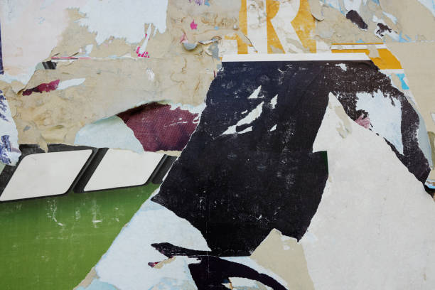 istock Pieces of torn paper peeling off wall used as billboard 1497483099