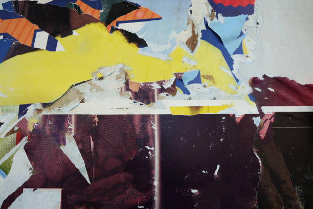 istock Pieces of torn paper peeling off wall used as billboard 1497483258