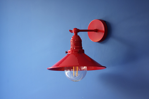 Red lamp on blue wall