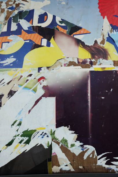istock Pieces of torn paper peeling off wall used as billboard 1497483592