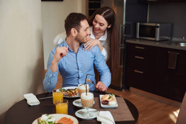istock Happy woman hugging man in the kitchen 1497484204