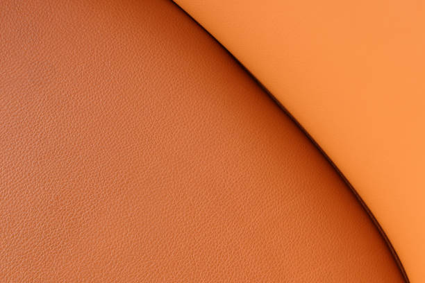 Orangefarbener Lederbeschaffenheitshintergrund, echtes Leder – Foto