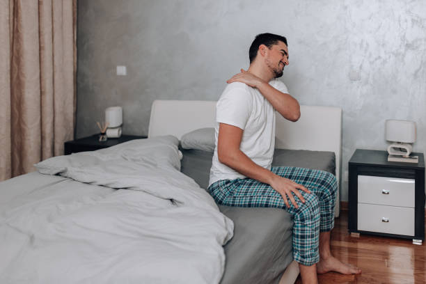 istock Young man touching his painful shoulder 1497485746