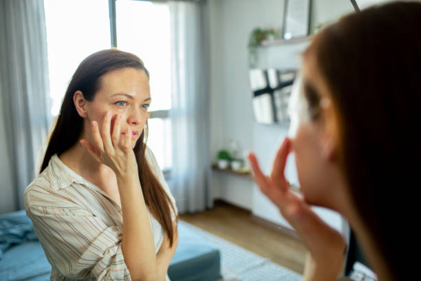 istock Young woman looking at a mirror at home 1497497687