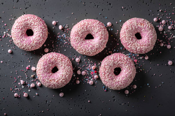 istock Yummy and fresh pink donuts for Fat Thursday festive. 1497506622