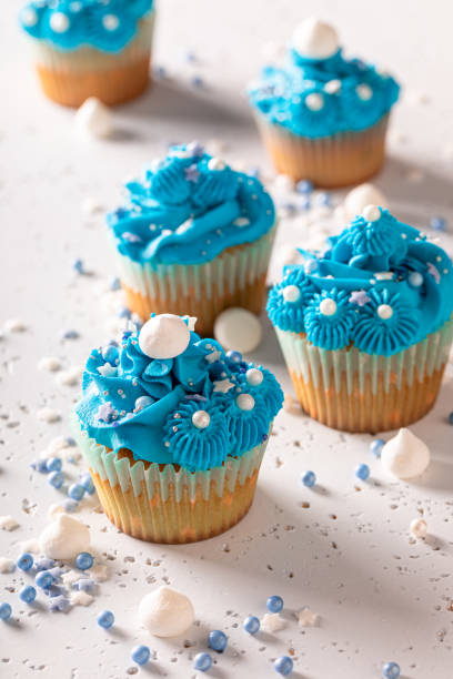 istock Beautiful and unique cupcakes with blue cream and sprinkles. 1497506629