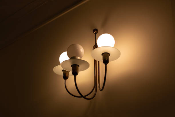istock Wall lamp with three arms with modern shape on the wall background 1497509134