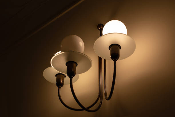 istock Wall lamp with three arms with modern shape on the wall background 1497509152