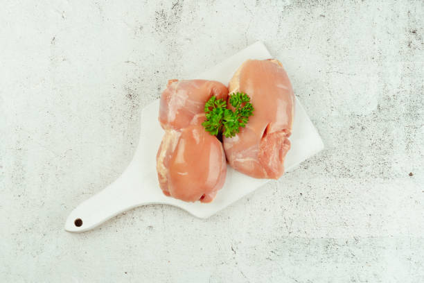 istock Fresh raw skinless chicken thigh meat with fresh herbs on a gray background.Copy space.Ogranic food,healthy eating.Food concept.Top view.Food for retail. 1497518516