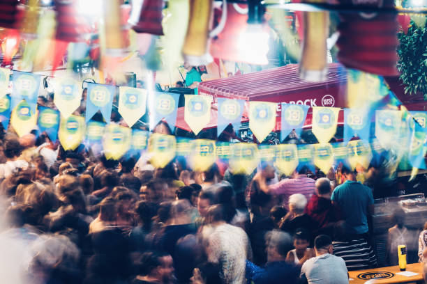 long exposure of people in lisbon street during popular saints festival in the gloria district - santos populares imagens e fotografias de stock