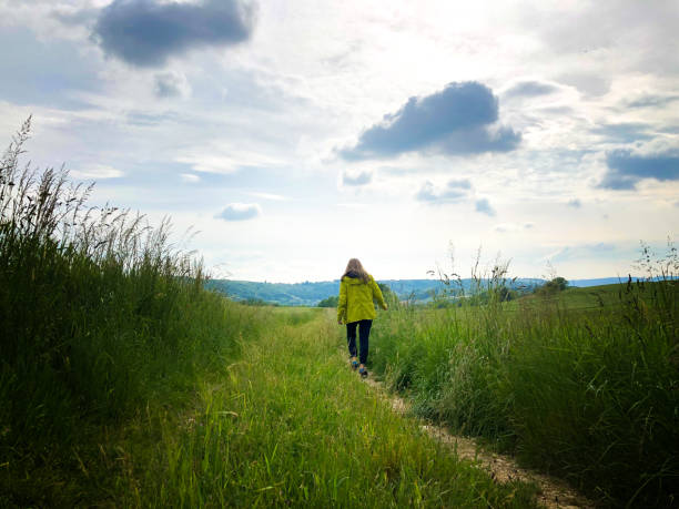 istock Woman Walking in Springtime Meadow (Isere, France) 1497533737