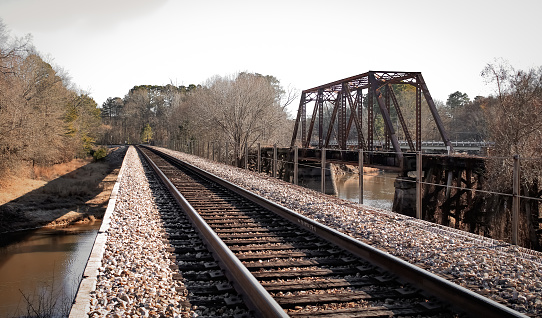 A steel railroad bridge over a river in Jefferson, Texas