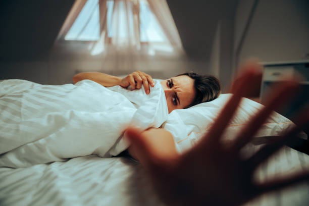 istock Woman Hiding under Sheets Making Stop Sign of Privacy 1497536564