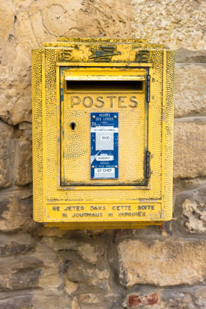 istock France: Vintage Yellow Public Mailbox (Postes) on Stone Wall 1497544808