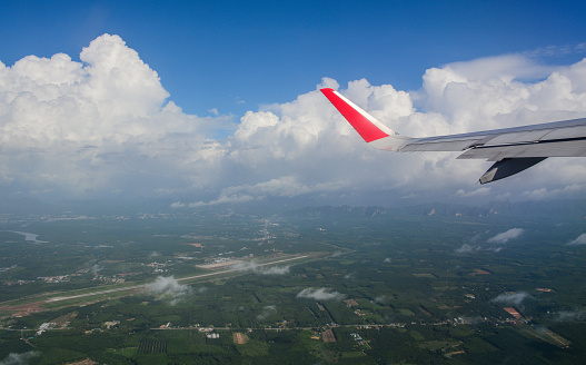 Chiang Mai, Thailand - Jun 22, 2016. Wing of civil aircraft on runway of Chiang Mai Airport, Thailand.